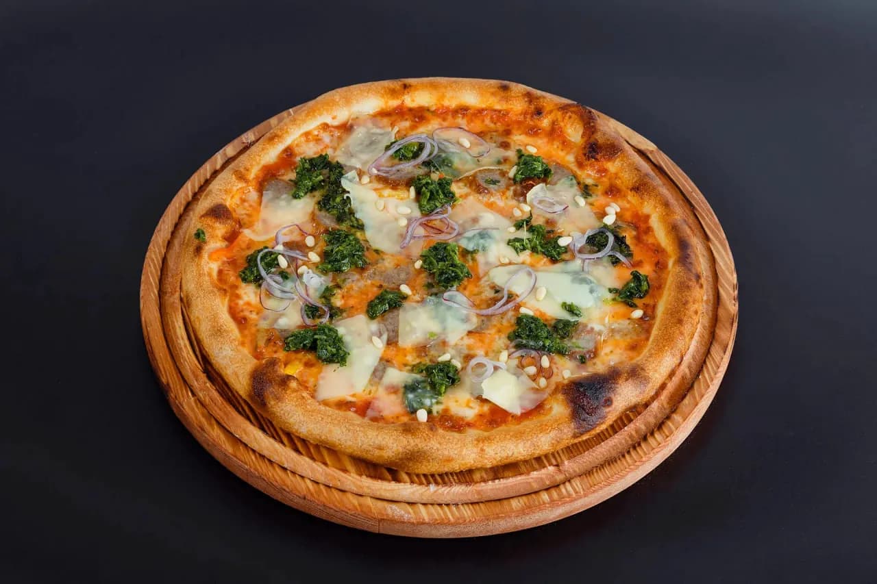 Pizza with sausages and pine nuts